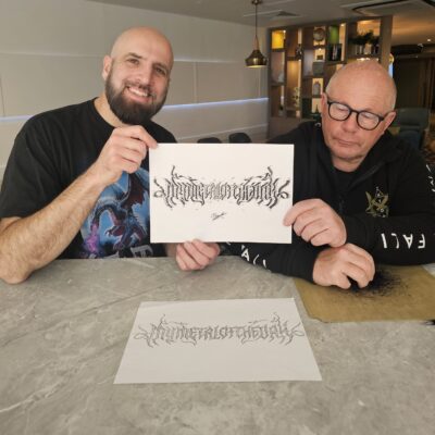 Christophe Szpajdel, aka "The Lord of the Logos" and mymetaloftheday David holding logo art